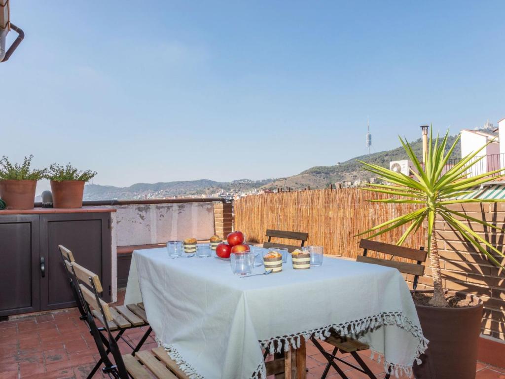 a table with fruit and drinks on a balcony at Apartment Gràcia- Parc Güell by Interhome in Barcelona