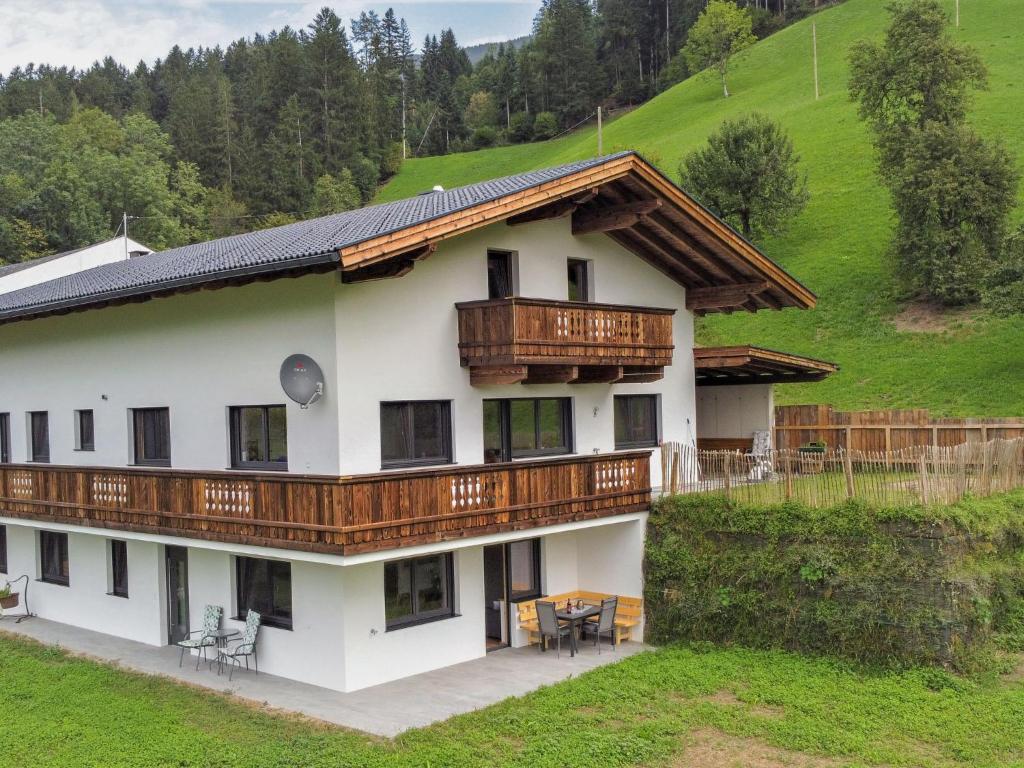 a large white house with wooden balconies at Apartment Mäuerlhof by Interhome in Hart im Zillertal