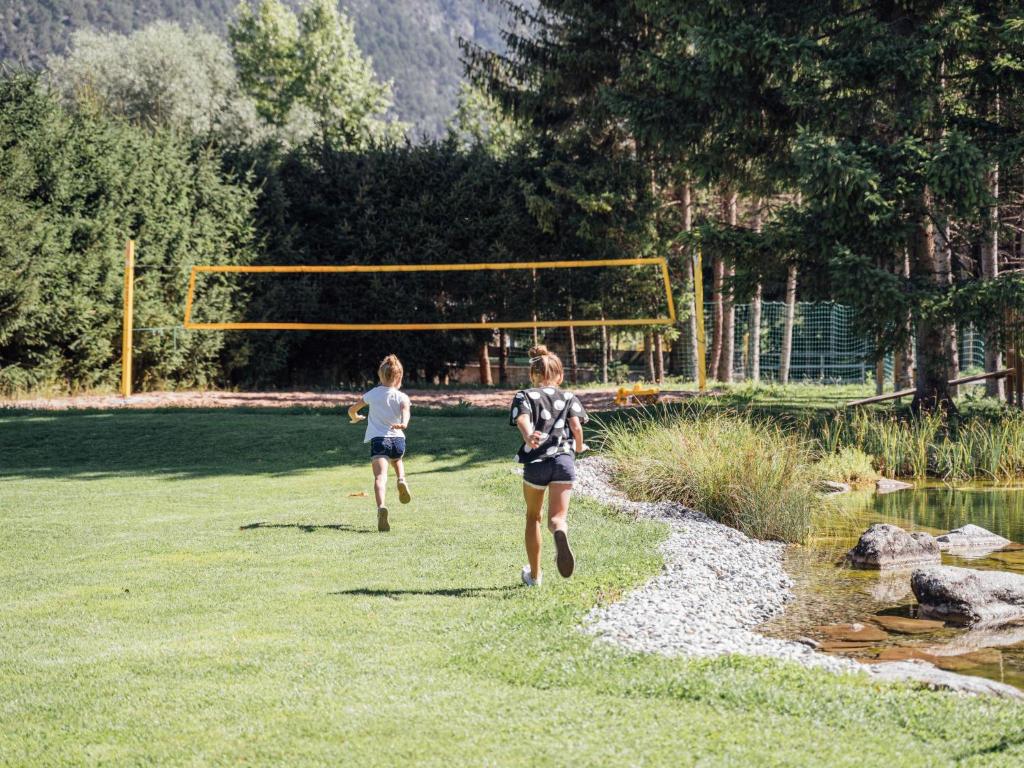 two girls running in a field with a goal at Apartment Max by Interhome in Stams