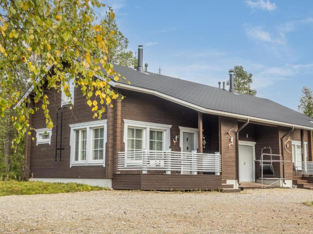 a wooden house with a gambrel roof at Holiday Home Kuurankuksa a by Interhome in Sirkka