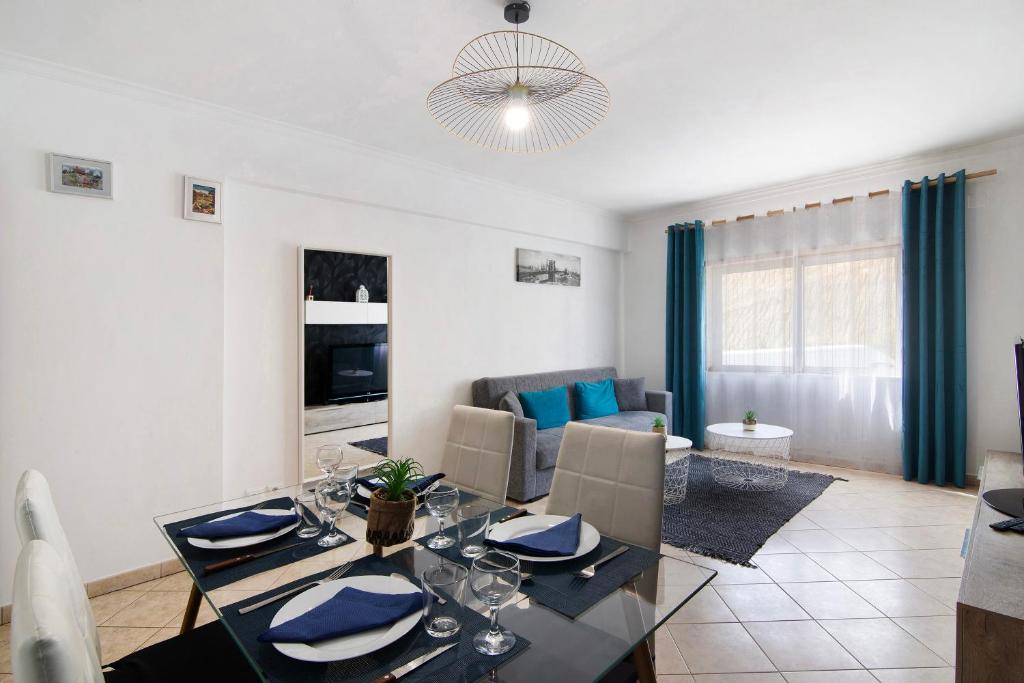a dining room and living room with a dining table at Apartamento do Sol in Albufeira