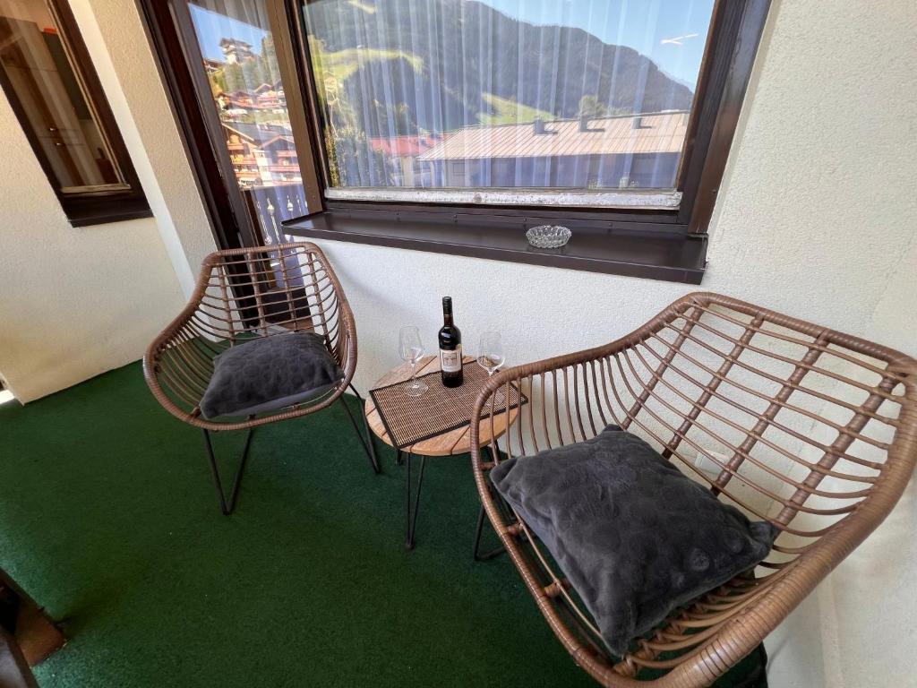 a room with two chairs and a table and a window at Apartment Flachgau by Interhome in Saalbach-Hinterglemm