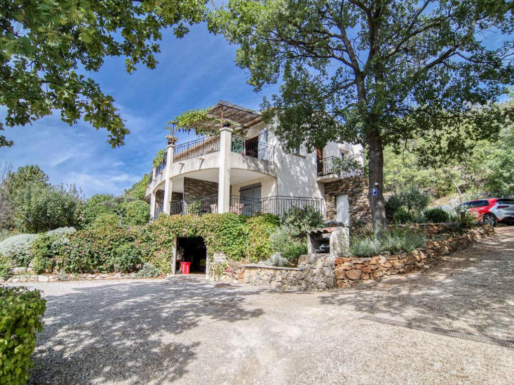 a large white house with a balcony at Apartment Mas des Grives by Interhome in Bauduen