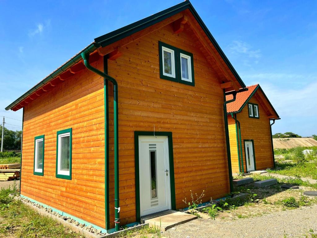 mały drewniany dom z białymi drzwiami w obiekcie Holiday Home Hakuna Matata with sauna w Spielbergu