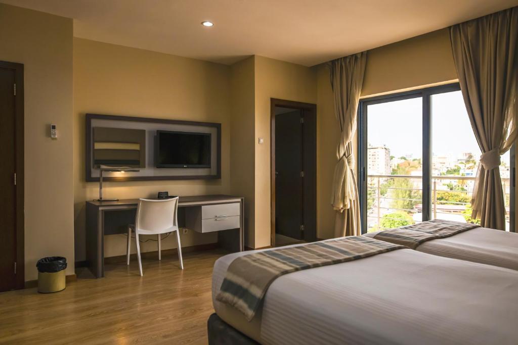Postel nebo postele na pokoji v ubytování Hotel Maputo lda