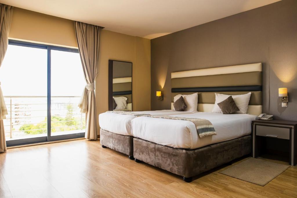 Postel nebo postele na pokoji v ubytování Hotel Maputo lda
