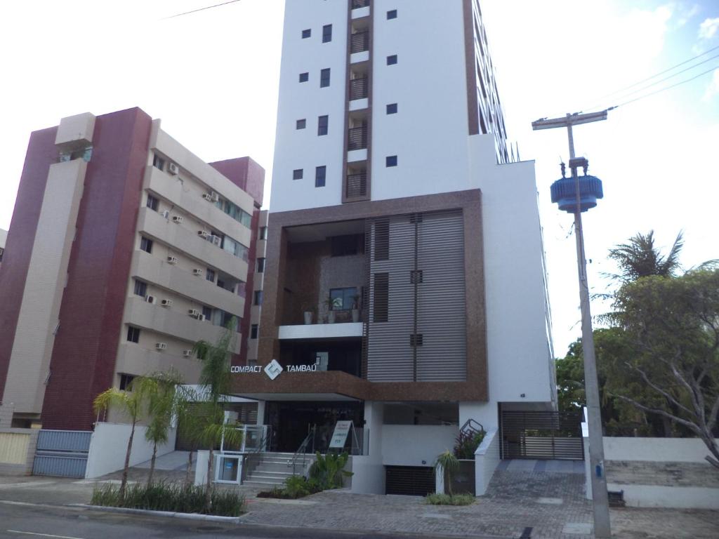 a tall white building with a building at Compact Tambaú 408 in João Pessoa