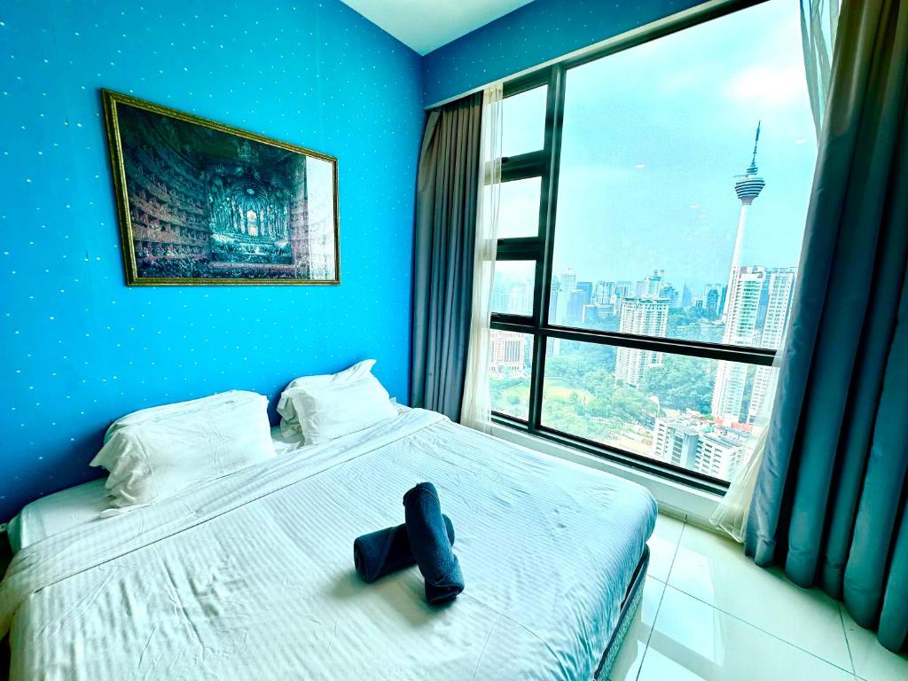 a blue room with a bed with a shoe on it at The Robertson 2B at Bukit Bintang with Netflix,trx,klcc,pavilion,lalaport in Kuala Lumpur