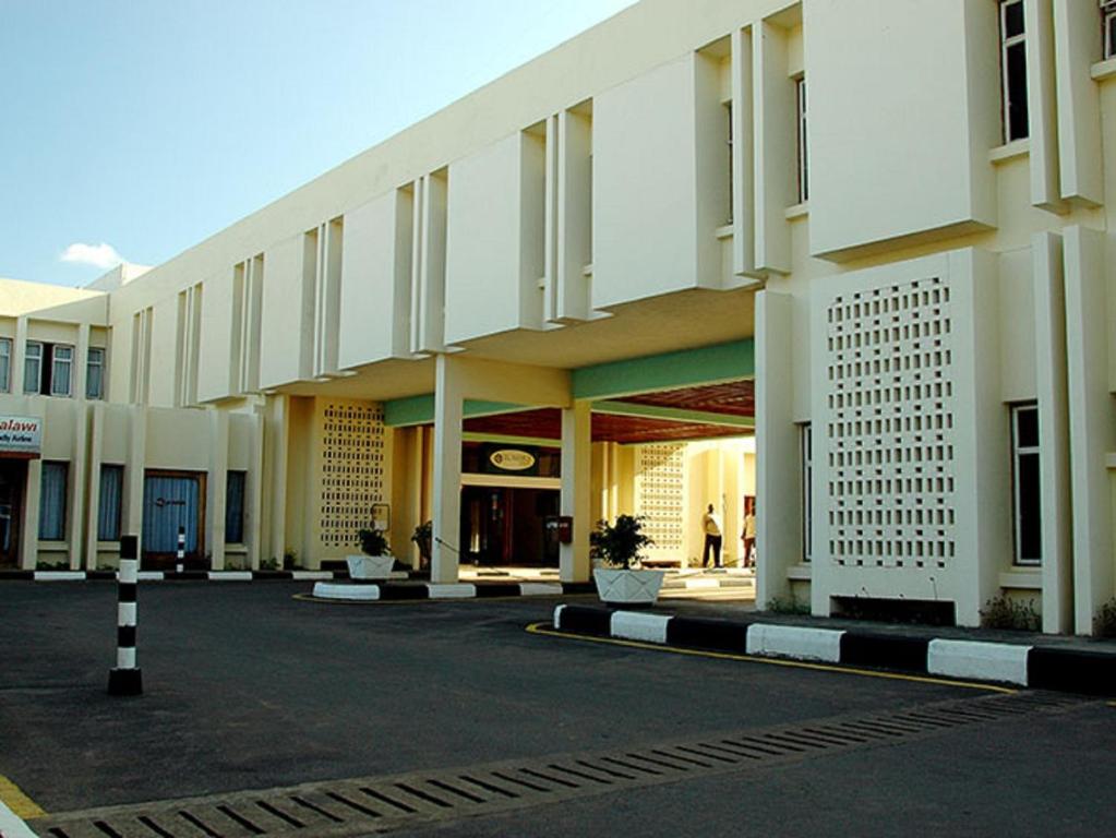 a large building with a street in front of it at Sunbird Mzuzu in Katoto