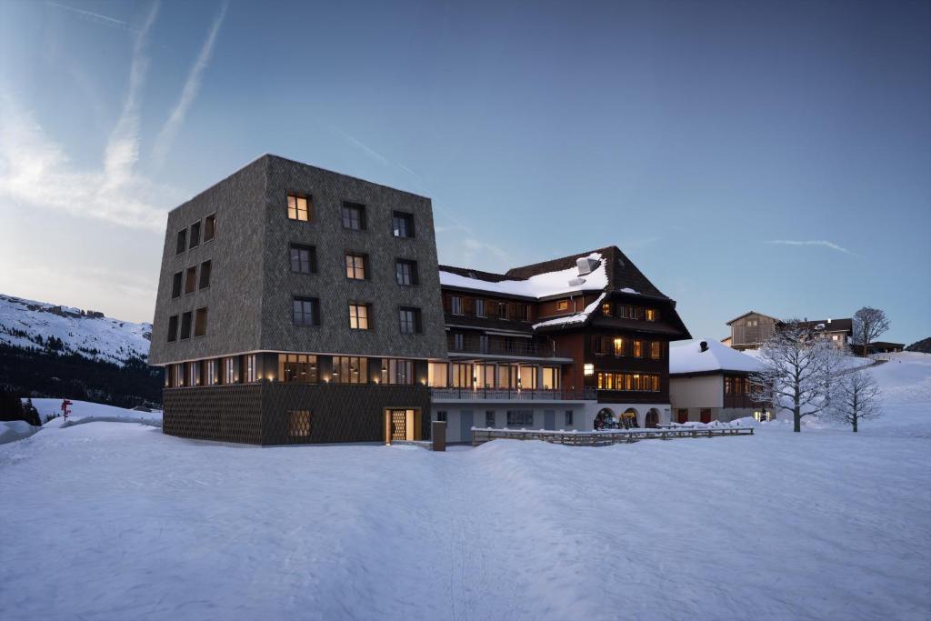 a large building in the snow in the snow at Bergwelten Salwideli in Sörenberg