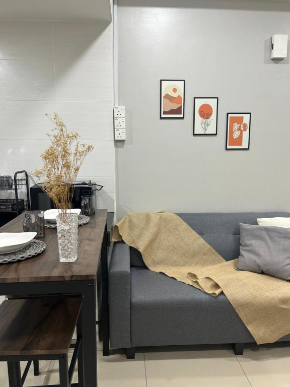 a living room with a couch and a table at The Sugar Barn 1 Bedroom D Perdana Kota bharu in Kota Bharu