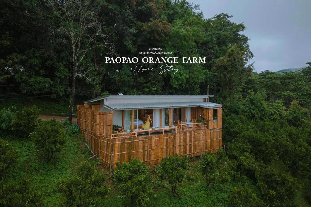 a small house in the middle of a forest at Paopao Orange Farm and Home stay in Mae Rim