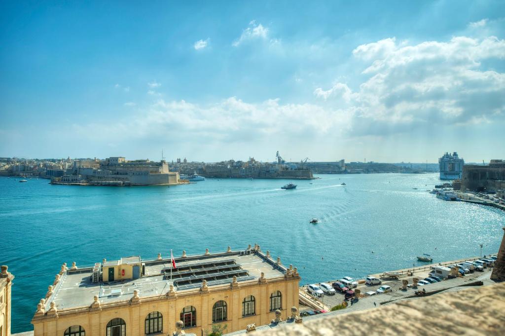 a view of a body of water with a building at 1bedroom-stunning views in Valletta center JSPI1-1 in Valletta