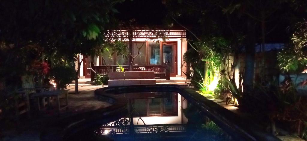 a house with a swimming pool at night at Giliranta in Gili Trawangan