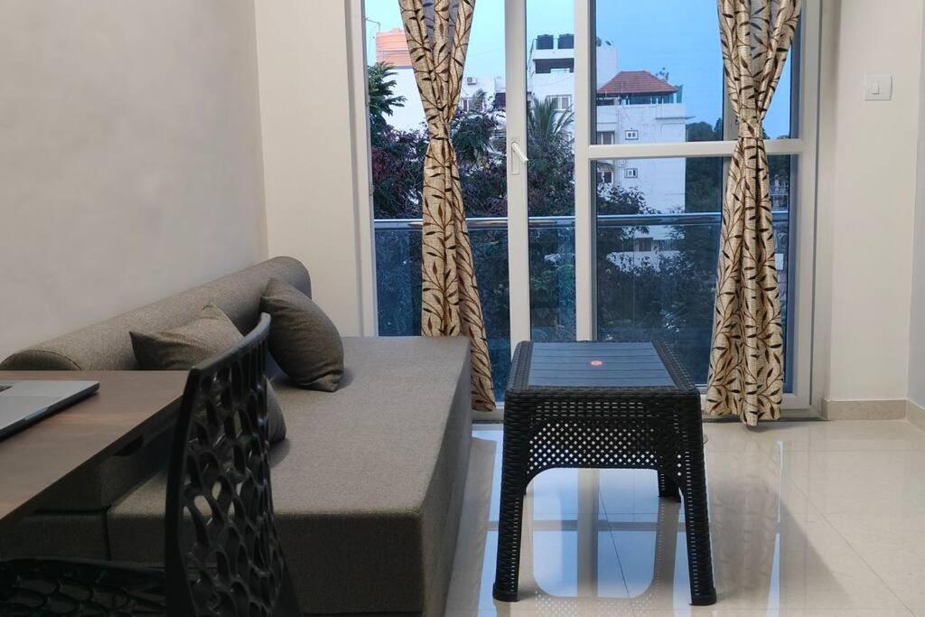 a living room with a couch and a table at Compact yet beautiful 1bhk 305 in Bangalore