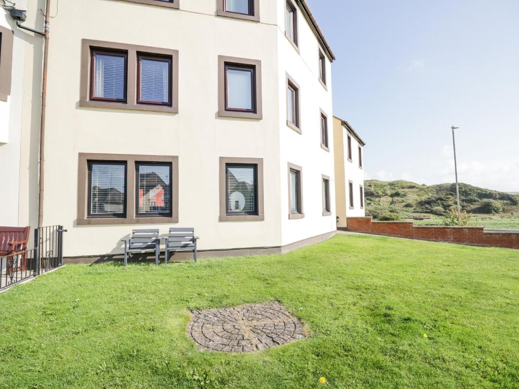 a building with a lawn in front of it at Alauna View in Maryport