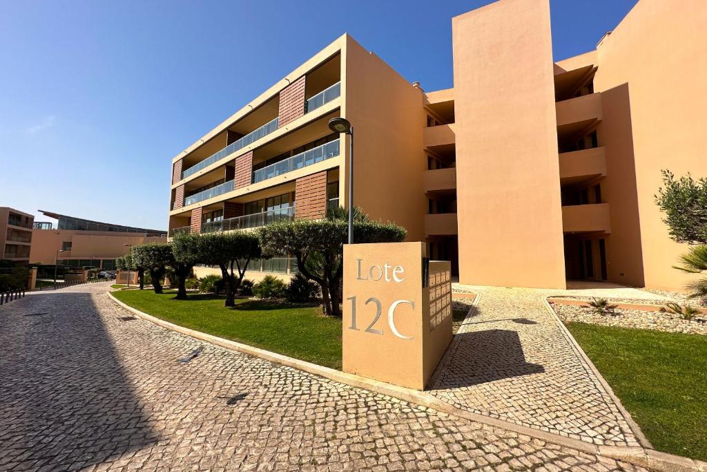 a building with a lease sign in front of it at Herdade dos Salgados, T2 12C 3D, Vila das Lagoas in Albufeira