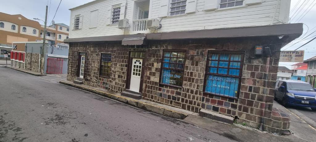 an old brick building on the side of a street at E.W.B. Properties in Basseterre