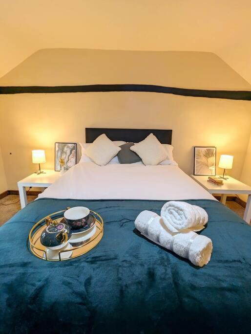 a bedroom with a bed with a tray of food on it at 3-Bed, Sleeps 6, 1 Bath, Parking, WiFi in Shalford