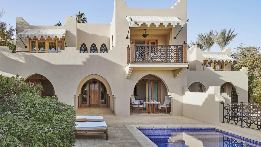 a house with a balcony and a swimming pool at Royal Villas with private pool in Four-Season Sharm - By Royal Vacations EG in Sharm El Sheikh