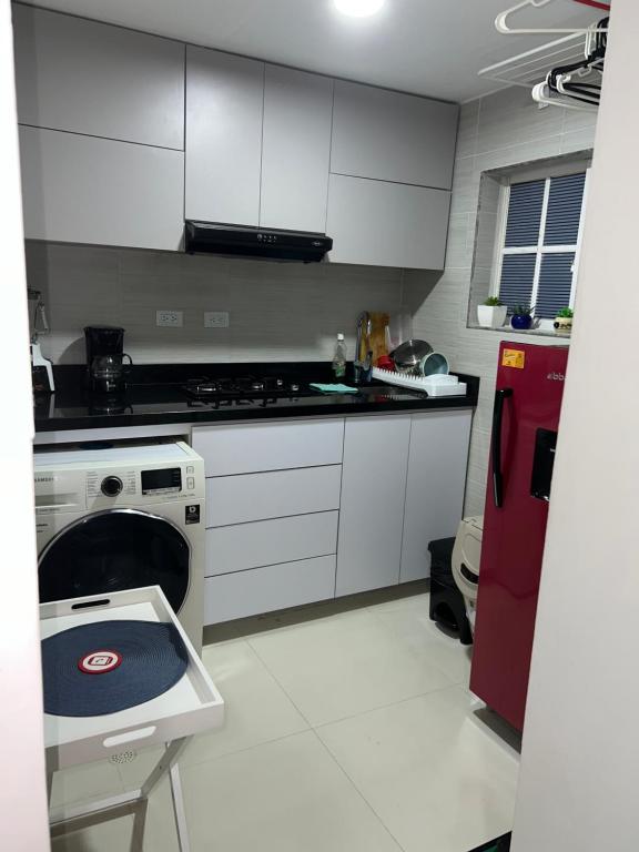 a kitchen with a stove and a dishwasher in it at Apartaestudio Barranquilla Recreo, primer piso in Barranquilla