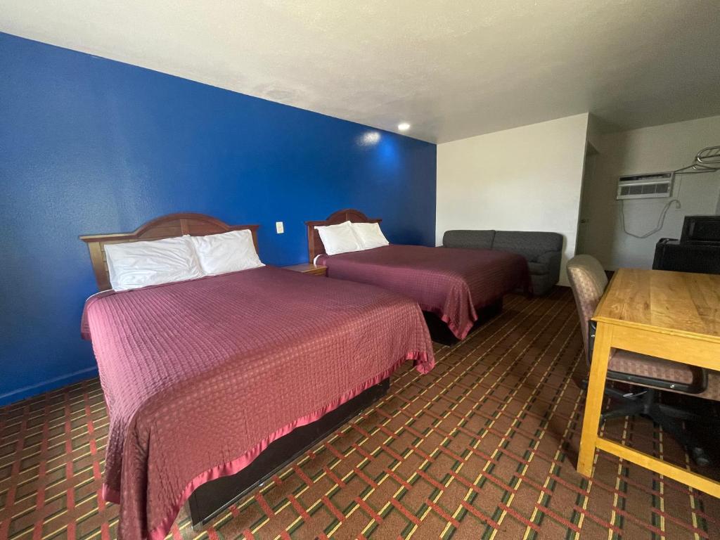 a hotel room with two beds and a table at Red River Inn 