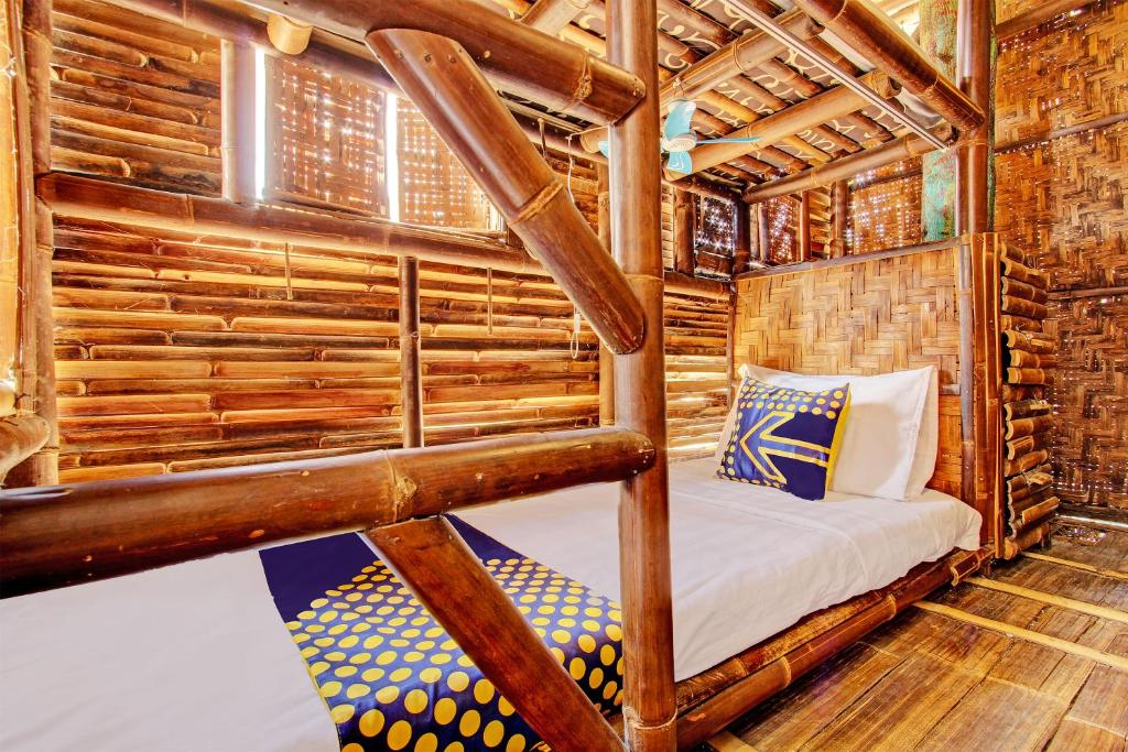 a bedroom in a log cabin with a bed at SPOT ON 93006 Waithozz Bunkbeds in Yogyakarta