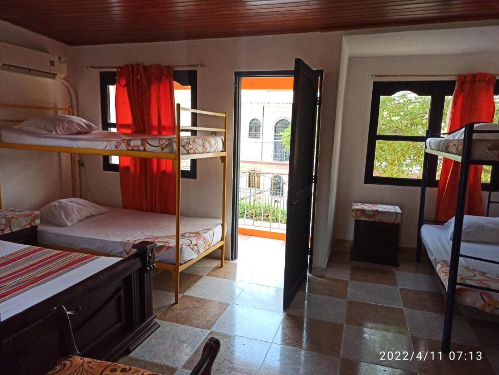 a room with bunk beds and a hallway with a window at Casa Eguis in Gaira