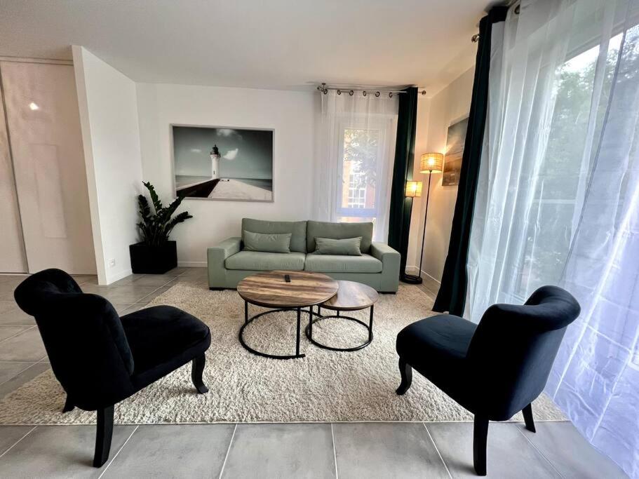 a living room with a couch and a table and chairs at !NEW! Disney/Paris - 50m RER A in Noisy-le-Grand