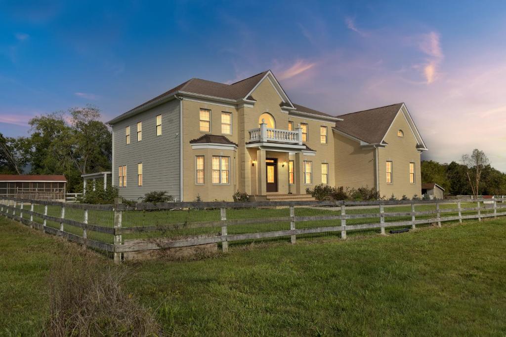 a large house with a fence in front of it at Bull Run Estate- Luxury Retreat with Scenic Views home in Haymarket