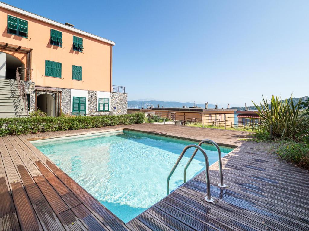 a swimming pool on a wooden deck next to a building at Appartamento le isole M in Portovenere