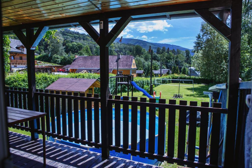 a view from the porch of a house with a playground at Chalupa Sedmidvory in Vernířovice
