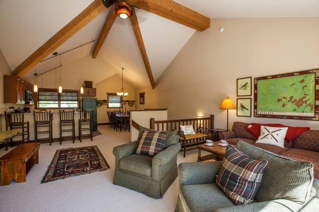 a living room with a couch and chairs and a kitchen at Whiteface Mtn. Winter Adventure Getaway in Wilmington