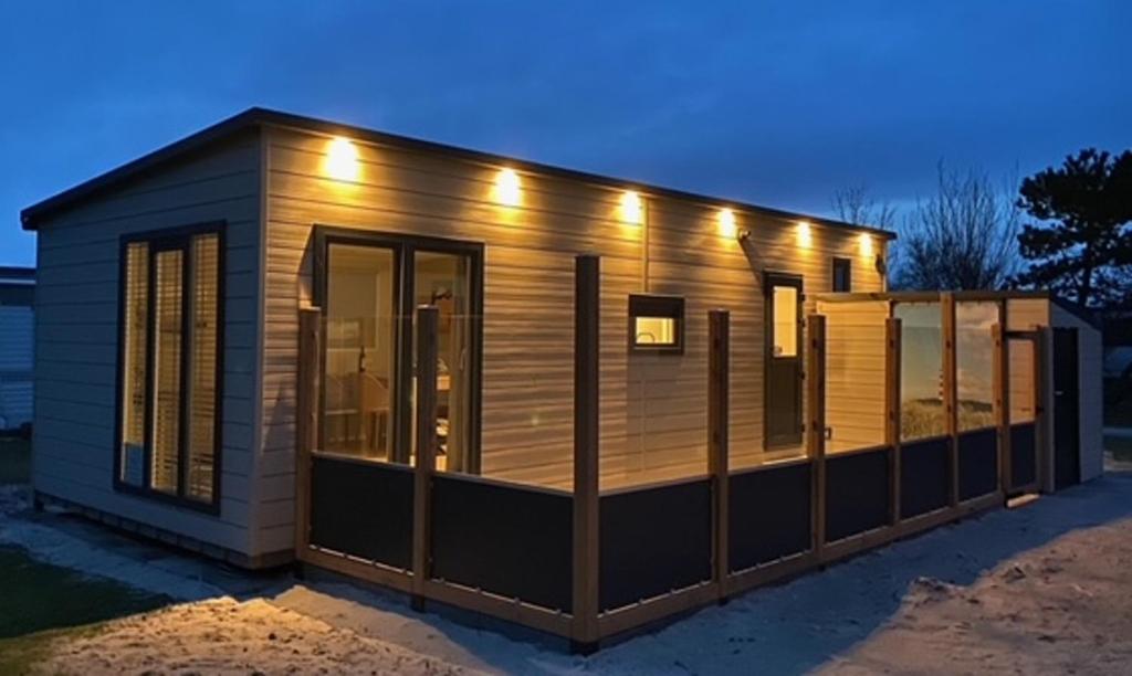 a tiny house with lights on it at Chalet2rent Ameland in Ballum