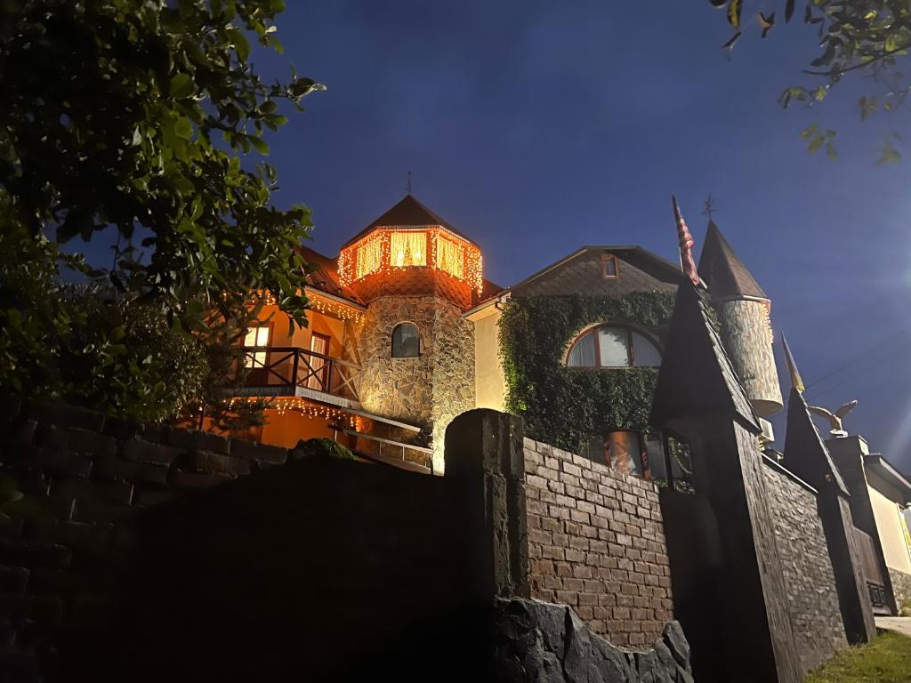 a house with a lit up tower on top of it at Polyanskiy Zamok in Polyana