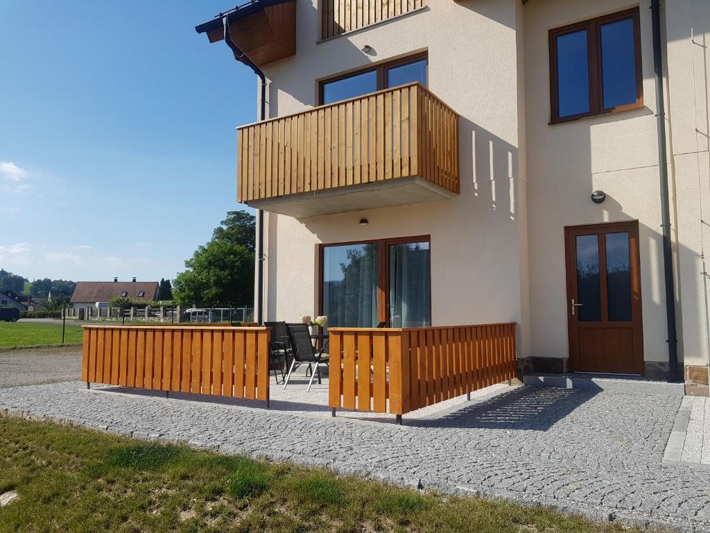 a house with a balcony and a patio at Barbora in Kašperské Hory