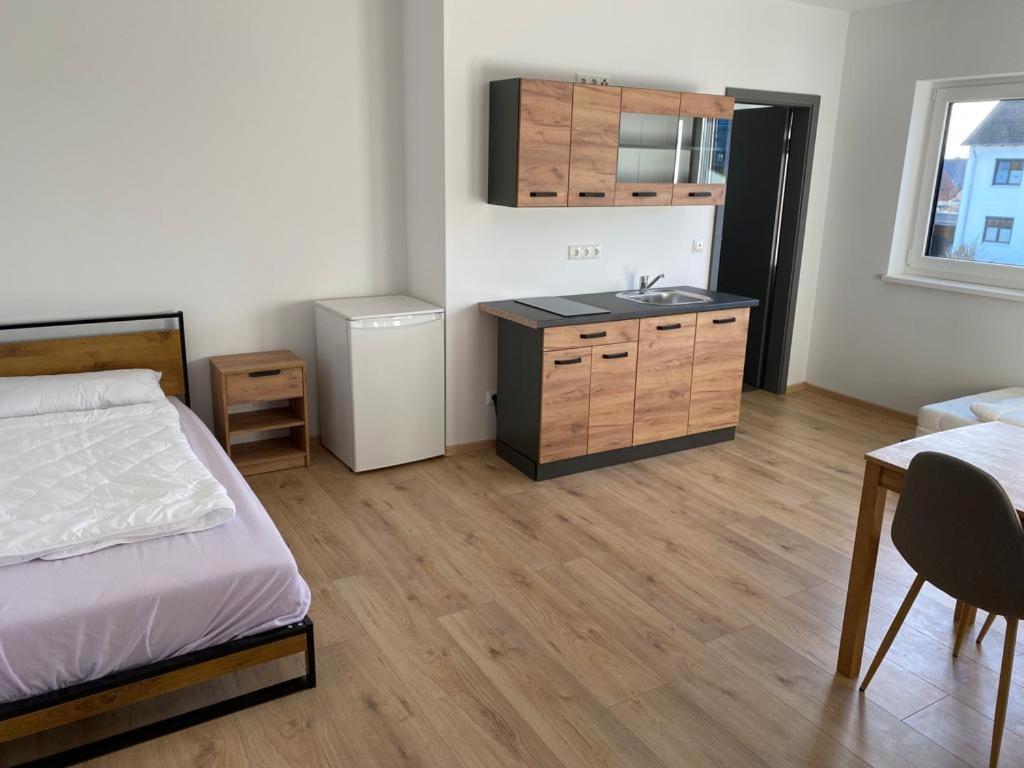 - une chambre avec un lit et un lavabo dans l'établissement Zimmer mit Bad und Küche, 