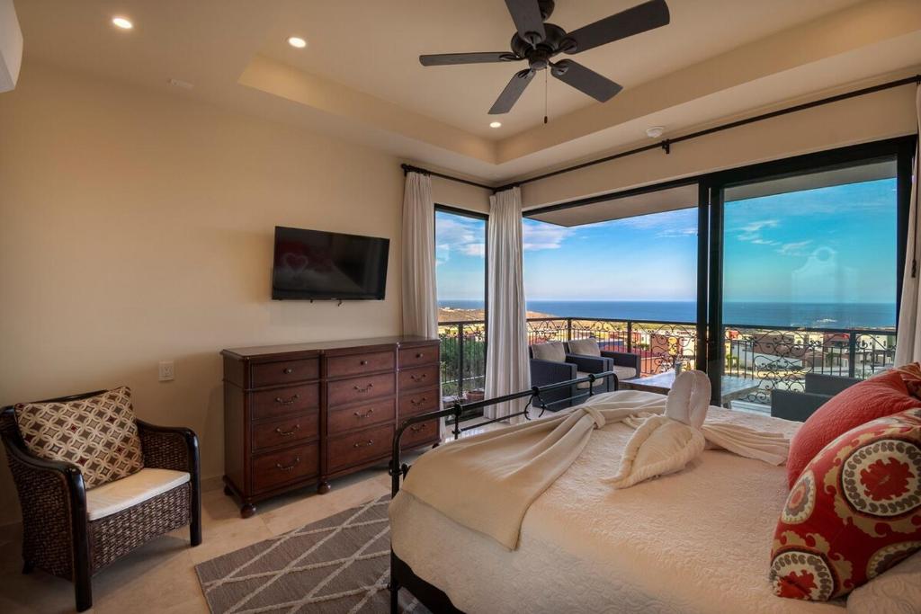 a bedroom with a bed and a large window at Memory Maker Copala Corner Unit Ocean View in Cabo San Lucas