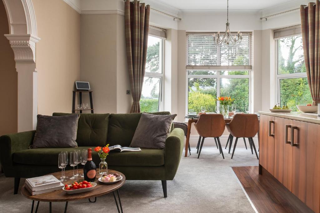a living room with a green couch and a table at Number 3 in Trefriw