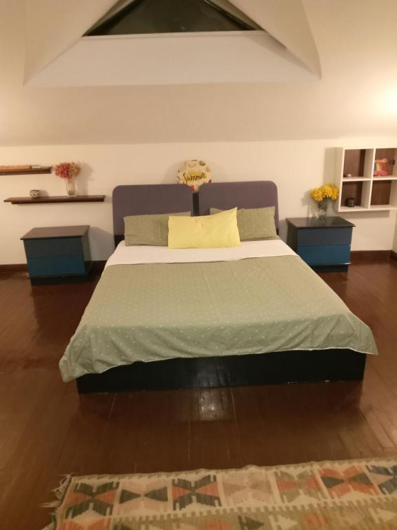 a bedroom with a large bed with two tables at Paradise Manavgat in Manavgat