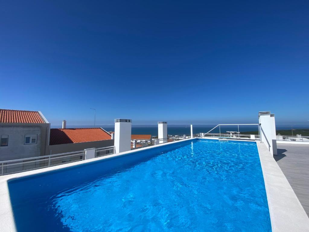 a large swimming pool on the roof of a building at Luxury flat with ocean view Nazaré Sitio in Nazaré