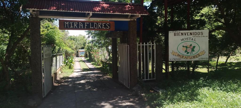 a gate to a park with a sign and a fence at Hostal Miraflores B&B in Santo Domingo