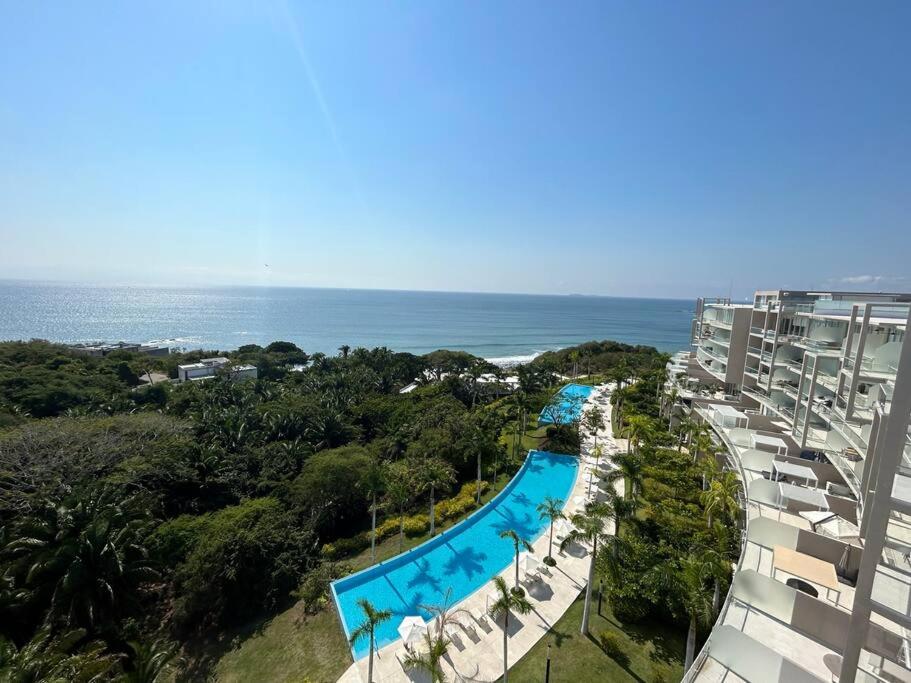 an aerial view of a swimming pool and the ocean at Departamento Pacific Luxury Punta Mita, Beachfront in Higuera Blanca