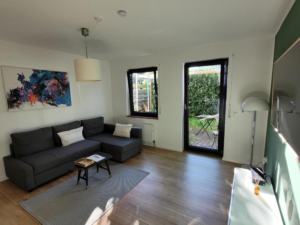 a living room with a couch and a table at Terrassenwohnung in Siegburg in Siegburg
