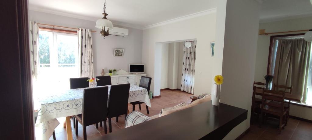 a dining room and living room with a table and chairs at Lethes View Apartamentos Turisticos in Ponte da Barca