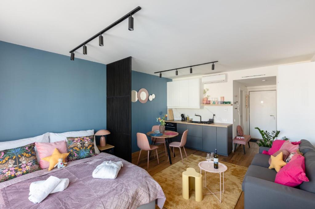 a bedroom with a bed and a living room at Urban Chic Residences in Prague