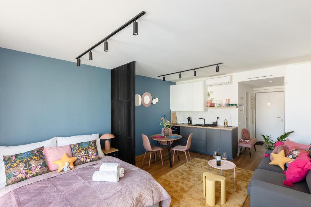 a bedroom with a bed and a living room at Urban Chic Residences in Prague