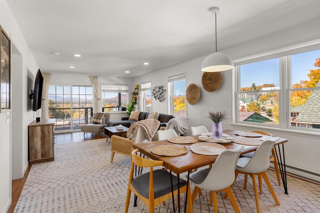 a dining room and living room with a table and chairs at Amazing Mountain Views Lake Placid & 1980 Olympic Center in Lake Placid