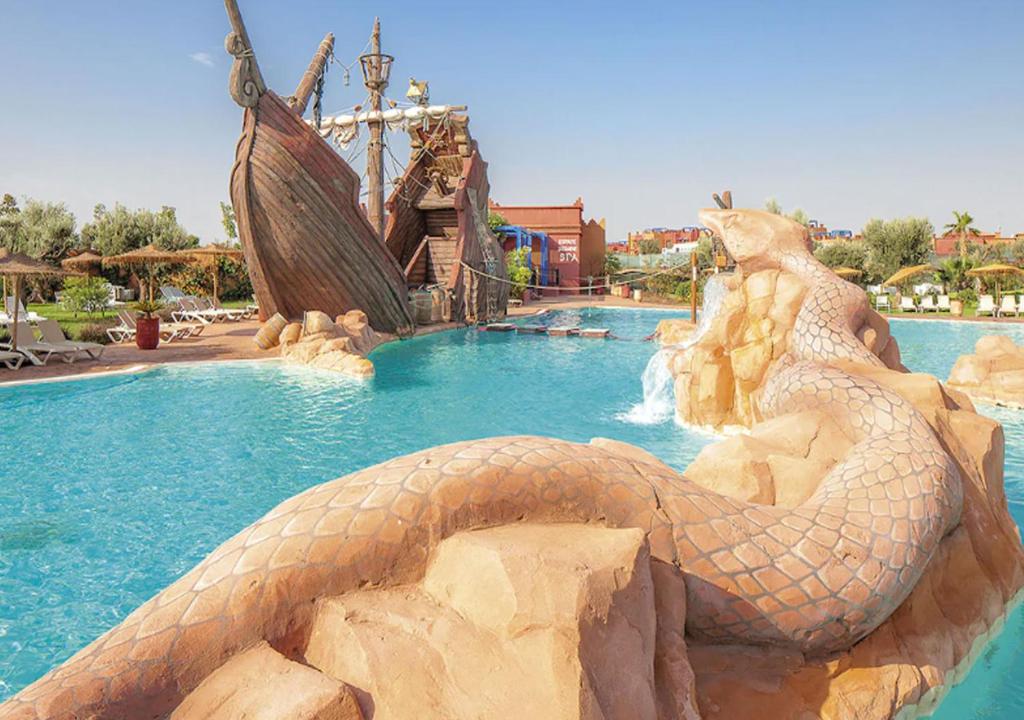 a fake snake in a pool at a resort at Appartement Vizir 112 in Marrakesh