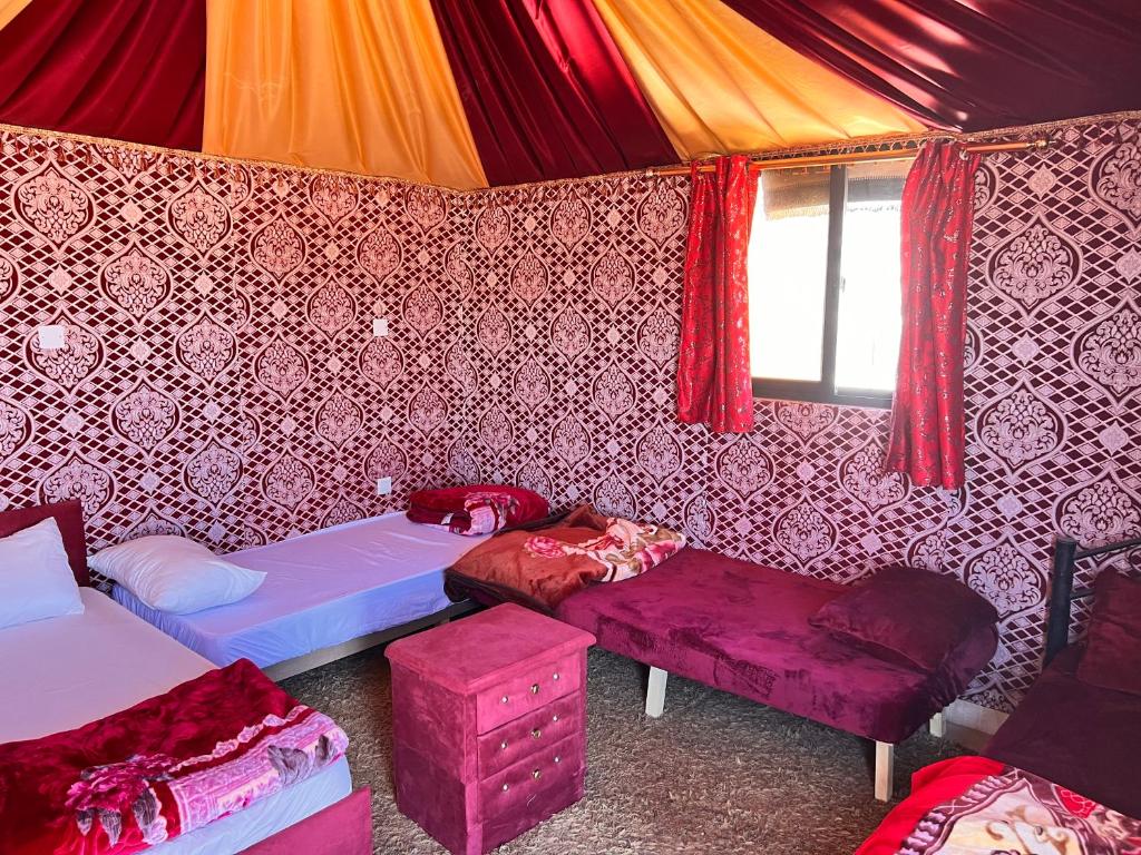 瓦迪拉姆的住宿－Raja camp，一间设有两张床和一张桌子及椅子的房间